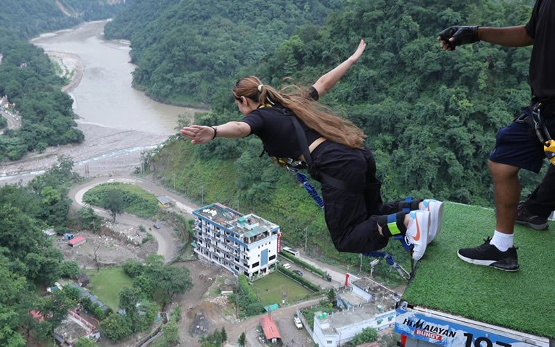 Girl jumping off from bungee platform in shivpuri